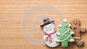 Christmas cookies, snowman, X`mas tree, gingerbread flat lay on wooden cutting board background top view for Xmas party holiday