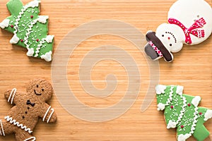 Christmas cookies, snowman, X`mas tree, gingerbread flat lay on wooden cutting board background top view for Xmas party holiday