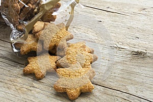 Christmas cookies in star shape falling from a cellophane bag on