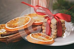 Christmas cookies tied with ribbon and other decorations closeup vintage toned photo