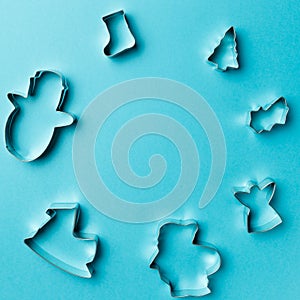 Christmas cookies various shape cutter on blue background with copy space. Top view. Flat lay. Trendy colorful photo