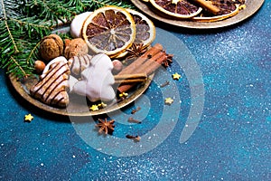 Christmas cookies witch chocolate, gingerbread cookies, nuts and fir twigs on dark background.