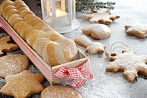 Christmas cookies on wooden background with powdered sugar