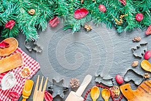 Christmas Cooking Utensils and Christmas Tree on Dark Stone Background, Top View