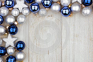 Christmas corner border of blue and silver ornaments on gray wood
