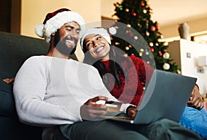 Christmas, couple and couch with laptop, credit card and together for finance, festive season and ecommerce in lounge