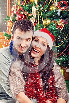 Christmas couple happily smiling enjoying holidays and snow