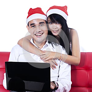 Christmas couple with a laptop