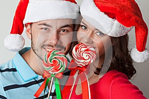 Christmas couple with lollipops