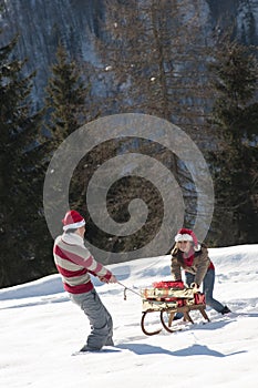 Christmas couple playing with gifts in the snow