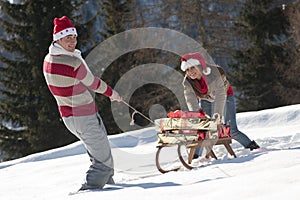 Christmas couple playing with gifts in the snow