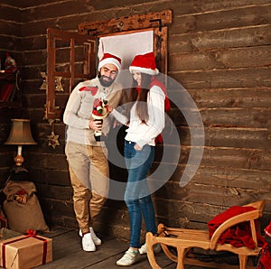 Christmas couple in rural wooden house playing toys