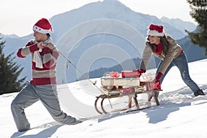 Christmas couple with sled and gifts