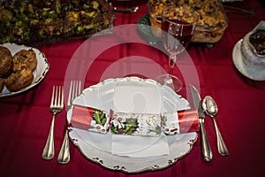 Christmas cracker on plate with red wine on Christmas dinner table