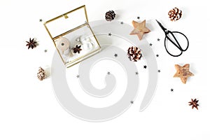 Christmas craft composition. Silk ribbons and Christmas balls in golden glass box. Vintage scissors, pine cones, silver