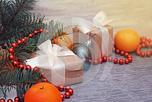 Christmas Craft Gift Boxes. Red Beads and Fir Branches. Cristmas Background. Tangerine and New Year presents.