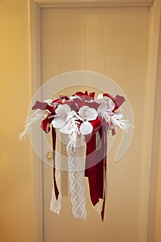 A christmas craft wreath made of fabric hangs in the home