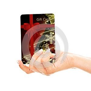 Christmas credit card holded by hand over white