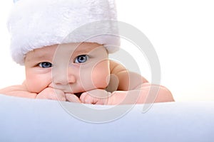 Christmas cute baby boy lying on blue soft plaid like on snowdrift