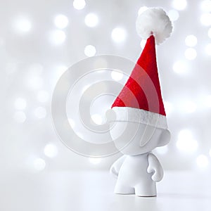 Christmas toy in Red Hat Santa Claus, Symbol New Year, Defocused Lights White Background