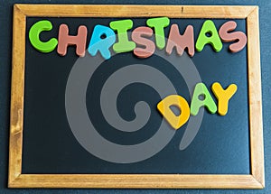 Christmas day wooden word on black board