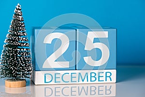 Christmas. December 25th. Day 25 of december month, calendar with little christmas tree on blue background. Winter time