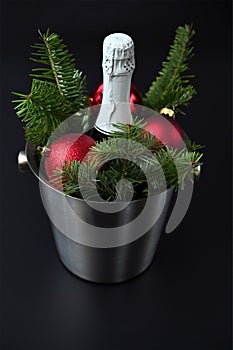 Christmas decor, champagne bottle, fir branches and red balls