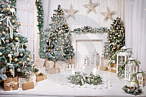 Christmas decor. Christmas tree decorations and holiday homes. New Year`s interior with a fir tree in white tones