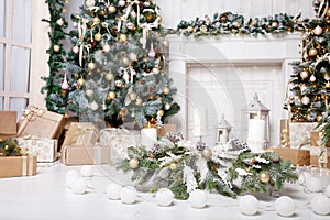 Christmas decor. Christmas tree decorations and holiday homes. New Year`s interior with a fir tree in white tones