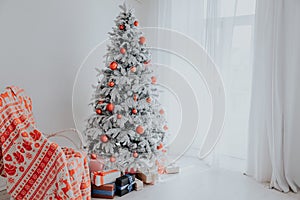 Christmas Decor Christmas tree with presents in a white room in winter