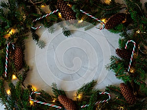 Christmas decor with cones, candies and fairy lights photo