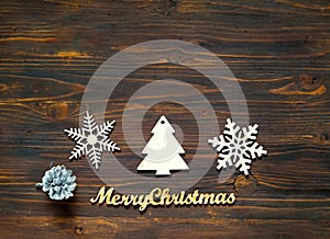 Christmas decor. Decorative wooden snowflakes and Christmas decorations on wooden background, concept of New Years holiday,closeup