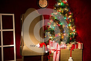 Christmas decor with fir tree and an armchair.