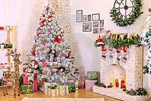 Christmas decor of the living room . the decoration of the room. Christmas snow-covered fir tree with toys. gift boxes under the