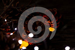 Christmas decor on a wooden board as a fonds with a garland and Christmas cones as a background