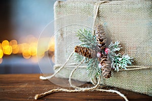 Christmas decorated gift on the background of lights. Free space for text.