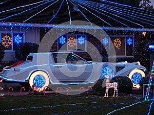 Christmas decorated house and dream car