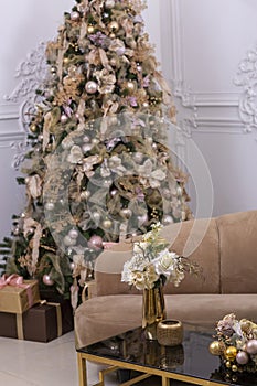 Christmas decorated room fragment with tree and golden balls, sofa closeup photo
