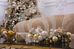 Christmas decorated room fragment with tree and golden balls, sofa closeup photo