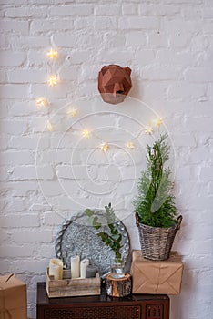 Christmas decorated rustic interior. White loft in Scandinavian style with brick wall with garland