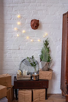 Christmas decorated rustic interior. White loft in Scandinavian style with brick wall with garland