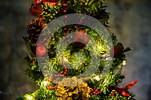 Christmas decorated small tree with red and gold decorations slowly lights up a light chain wrapped around a tree of yellow color photo
