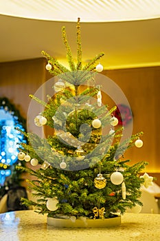 Christmas decorated tree in modern interior of living room, holiday concept