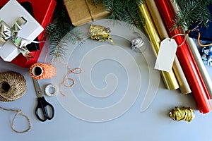 Christmas decorating present box on gray wooden background. New Year and Christmas decorations concept.