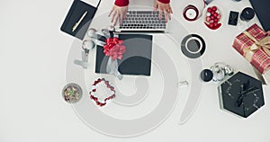 Christmas, decoration and above table with laptop, working and hands cleaning desk of clutter. Holiday, preparation and