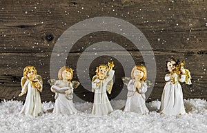Christmas decoration with angels on wooden background for a greeting card.