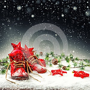 Christmas decoration with antique baby shoes. Falling snow