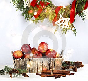 Christmas decoration with apples, cinnamon and pine cones