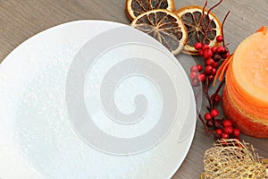 Christmas decoration background with white plate on wooden backg