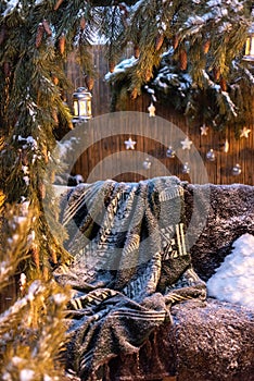 Christmas decoration in the backyard: a snowy swing with pillows and a cover